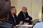 Srikumar Banerjee, the chairman of the Indian Atomic Energy Commission (right), and ITER Deputy Director-General Dhiraj Bora, talking to Indian staff members.